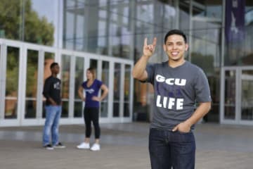 GCU student holding a lopes up