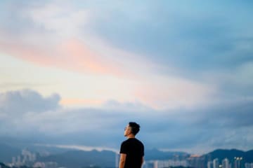 A person staring at the sunset