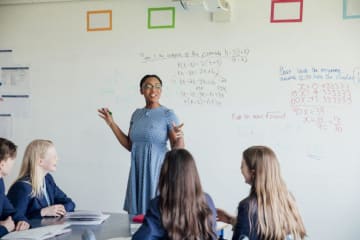 Math teacher working with eager high school students