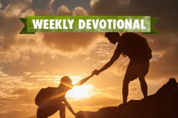 Weekly Devotional: One person helping another up a mountain
