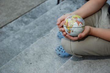 child holding a mini globe