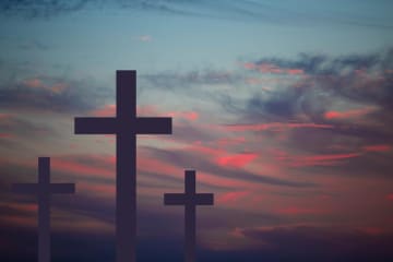 A hilltop of crosses at sunset