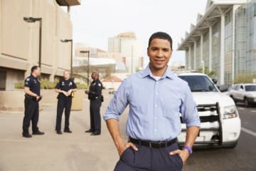 person in front of a cop car