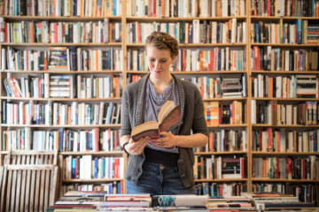 Woman reading books in a library