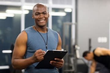 physical trainer holding clipboard