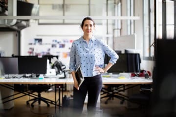 Businesswoman standing with digital tablet