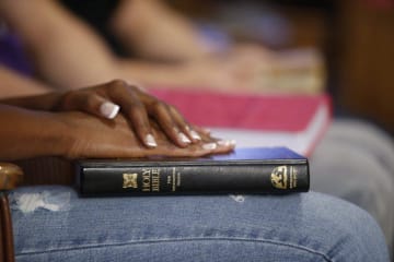 person holding bible on their lap