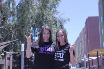 two girls holding a lopes up