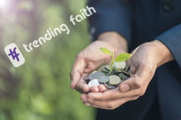 Hands hold coins with a plant sprouting out of them