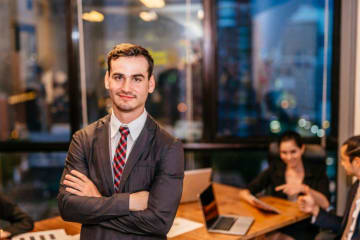 A businessman standing in front of a board room