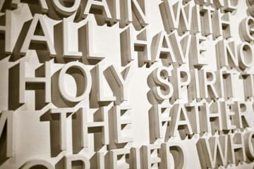 "holy spirit" written with white letters on a wall 