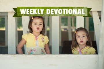 Two girls below the green weekly devotional logo