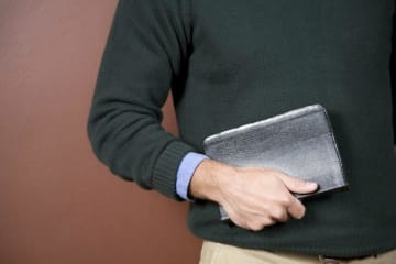close up of man holding his Bible 