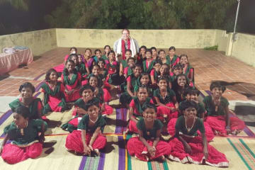 group of children sitting and smiling