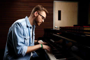 A man playing worship music on the piano
