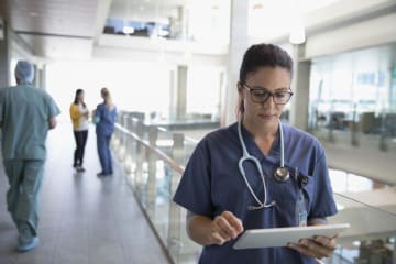 nurse looking at clip board