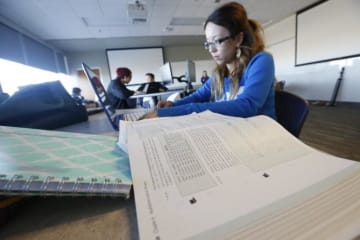 Student review textbooks in library setting