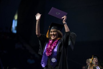 A GCU student celebrating at graduation