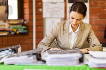 Woman grading stack of papers