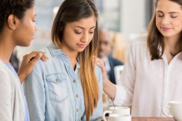 three people praying