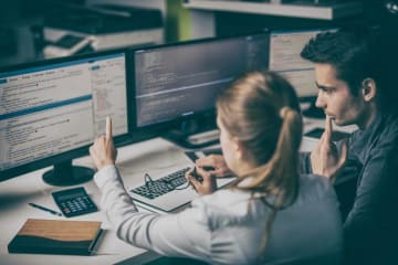 two people looking at a computer