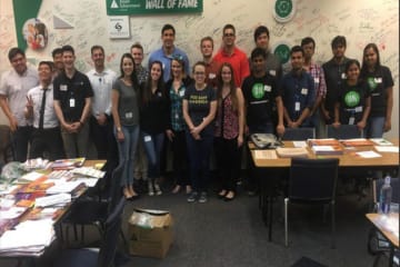 Group of students standing in front of Wall of Fame