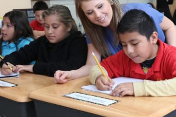 teacher helping her students in class