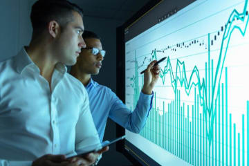 Two analytics team members reviewing business data