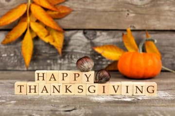 A "Happy Thanksgiving" sign with autumn leaves 