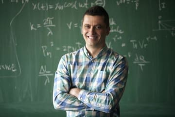 Man standing in front a chalkboard