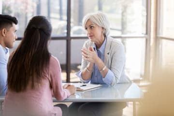 Female psychologist speaks with a young couple