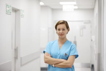 GCU graduate ABSN nurse standing in hospital hallway