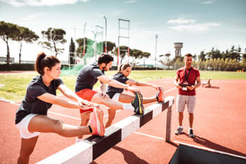 threes students stretching and working out in college