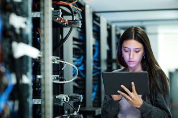 Information technology professional uses her tablet to work on a project