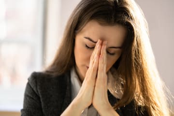 Woman praying since she has a love for God