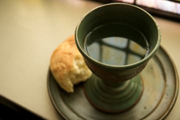 Communion bread and wine sitting on a window sill