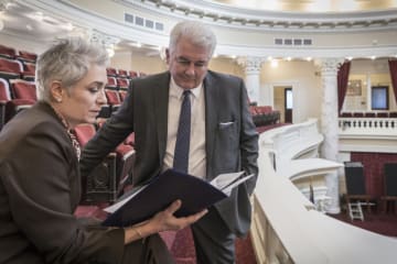 A politician consulting with their campaign manager