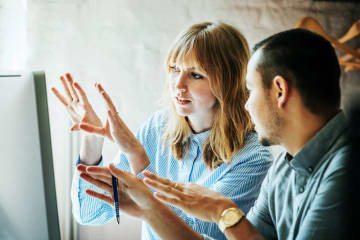 communication specialists problem solving together in an office