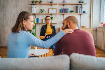 Couple discussing substance abuse recovery with counselor