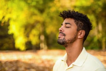 A man meditating outdoors