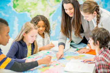 Woman teaching students geography