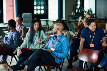 Diverse coworkers chatting during a work meeting