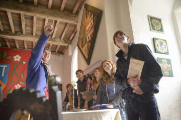 Male tour guide with a group of young tourists