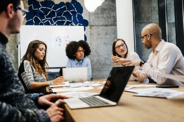 Male and female employee relations managers collaborating in office together