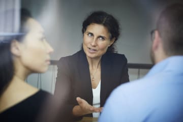 Loan officers meeting with clients in office