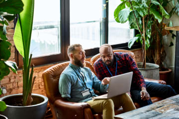 Mentor and mentee working together on laptop