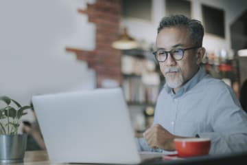 a doctoral student studying on laptop