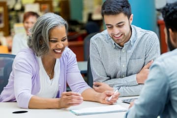 Doctoral students collaborating on an assignment