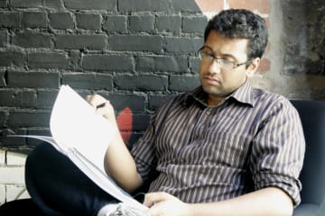 Man looking at notebook in chair