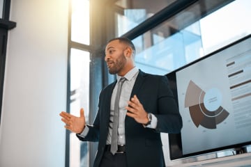 Male marketing manager presenting on types of research